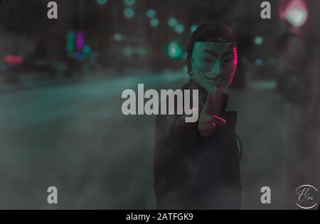 Person, die Kerl trägt, verwischt Maske im Dunkeln Stockfoto