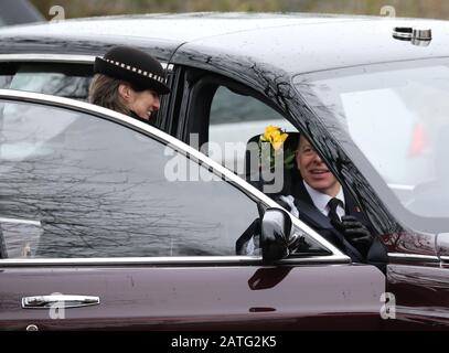 Sandringham, Großbritannien. Februar 2020. Der Fahrer des Autos der Königin erhält Blumen von einer Person in der Menge, bereit für den Valentinstag. Königin Elizabeth II. Besucht den Sonntagmorgen in der St. Peter & St. Paul Church in West Newton, in der Nähe von Sandringham, Norfolk. Ihre Majestät macht auch den kurzen Spaziergang zum Dorfhaus und trifft viele Wohlhabende, die die Strecke säumen. West Newton, Norfolk, am 2. Februar 2020. Credit: Paul Marriott/Alamy Live News Stockfoto