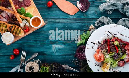 Sortiment an gesunden Lebensmitteln. Kalte und heiße Snacks. Auf Holzgrund. Draufsicht. Kopierbereich. Stockfoto