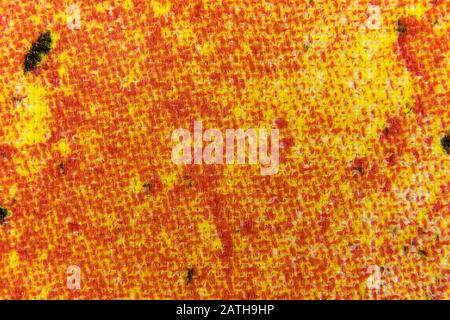 Bild von Homespun-Stoff in Gelb- und Rottönen Stockfoto