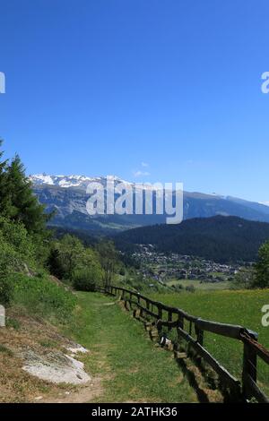 Wanderweg und Blick auf das Dorf Laax und Berge, Schweiz Stockfoto