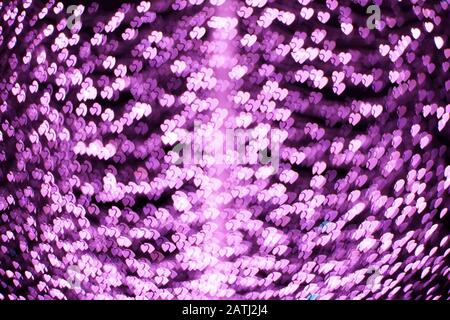 Rosafarbene Herzen bokeh Lichter. Schöner Hintergrund für den Valentinstag Stockfoto