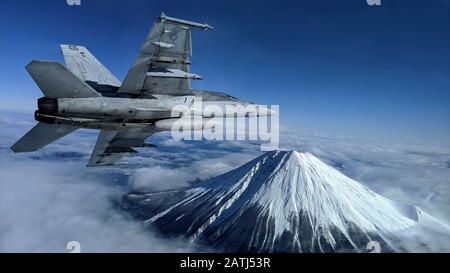 Ein Kampfflugzeug der U.S. Navy F/A-18F Super Hornet führt eine Bankendrehung in der Nähe des japanischen Wahrzeichen Mt. Durch. Fuji während des Flugbetriebs am 29. Januar 2020 in der Nähe von Atsugi, Japan. Stockfoto