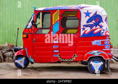 Seitenansicht eines geparkten roten peruanischen Tuk-Tuk, Auto-Rikscha, Peru Stockfoto