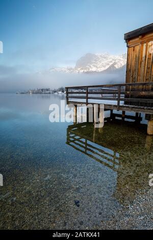 Holzsteg am Bergsee im Winter am Grundlsee in Österreich Stockfoto