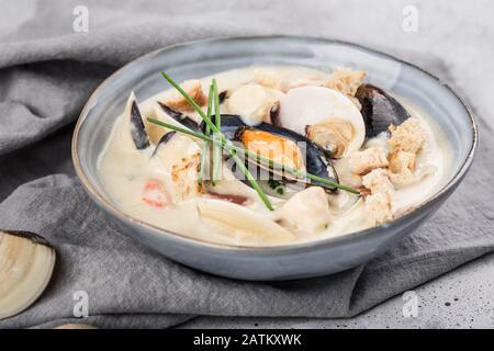 Klatschender Schwärmer in einer grauen Platte. Hauptzutaten sind Schalentiere, Brühe, Butter, Kartoffeln und Zwiebeln. New England Soup auch bekannt als Boston Clam Chowd Stockfoto