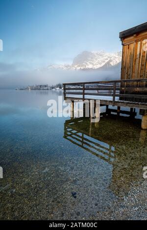 Holzsteg am Bergsee im Winter am Grundlsee in Österreich Stockfoto