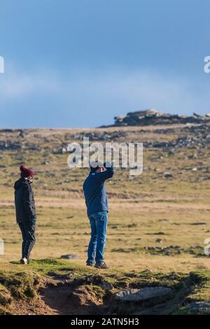 Wanderer, die sich auf den Gipfel des Rough Tor im Bodmin Moor in Cornwall vorbereiten. Stockfoto