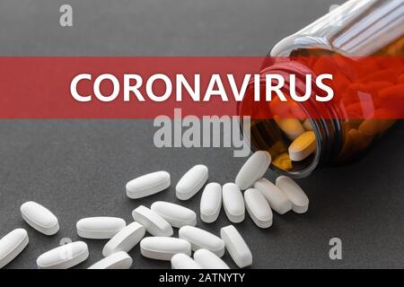 Weiße Pillen, die aus einer gestürzten braunen Flasche und einer Aufschrift verschüttet wurden. Behandlungskonzept für Coronavirus. Stockfoto