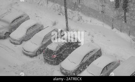 Moskau - 10. Januar: Fahrer reinigt am 10. Januar 2018 in Moskau, Russland, Schnee von der Windschutzscheibe. Stockfoto