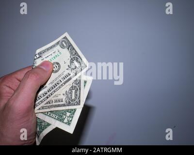 Die Hand hält und drückt die Dollar. Stockfoto