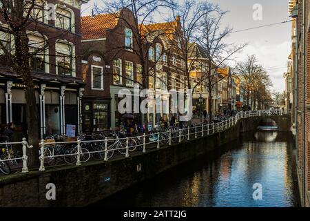 Delft, Niederlande, Holland, 18. Januar 2020. Blick auf Kanal und Straße, traditionelle Häuser und geparkte Fahrräder in der alten Innenstadt. Stockfoto