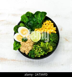 Grüner Gemüseschüssel Buddha. Quinoa, grüne Erbsen, Mais, Spinat, Brokkoli, Ei. Gesunde Ernährung. Draufsicht. Freier Speicherplatz für Ihren Text. Stockfoto