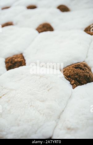 Weiße Plüschdecke mit braunen Diamanten und Quadraten Stockfoto