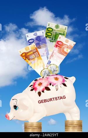 Huckepack vor trübem Himmel auf Euro-Münzen mit Euro-Scheine und Schriftzug Geburtstag, Deutschland Stockfoto