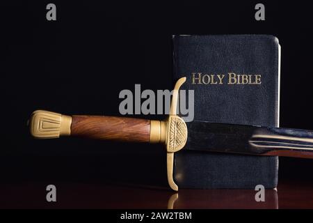 Altes Langschwert neben der Heiligen Bibel Stockfoto