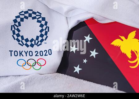 TOKIO, JAPAN, FEBRUAR. 4, 2020: Papua-Neuguinea-Nationalflaggen, offizielles Logo der Olympischen Sommerspiele in Tokio 2020. Weißer Hintergrund Stockfoto