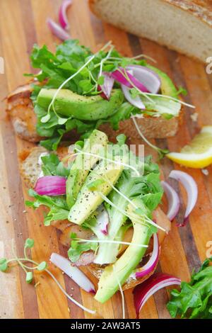 Ansicht von oben von Sandwich prep mit geräuchertem Lachs, Avocado, Salat und Sprossen Stockfoto