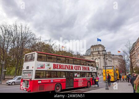 Berlin, Deutschland - 28. Oktober 2013: Sightseeing-Busse vor dem Reichstaggebäude. Die verschiedenen Busunternehmen nähern sich dem interessantesten Pl Stockfoto
