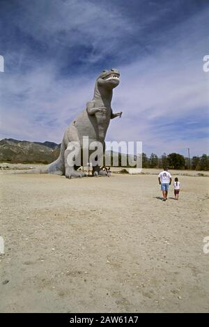 Touristen, die die riesige Dinosaurier-Roadside-Attraktion in Cabazon, CA, besuchen Stockfoto