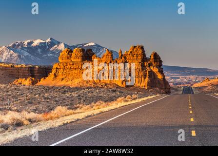 Sandsteinfelsen in der Nähe von Goblin Valley, Henry Berge in der Ferne, bei Sonnenaufgang, Colorado Plateau, Highway 24 in der Nähe von Hanksvlle, Utah, USA Stockfoto