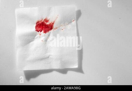 Küchenpapier Serviette im Blut. Blut mit improvisierten Mitteln stoppen. Stockfoto