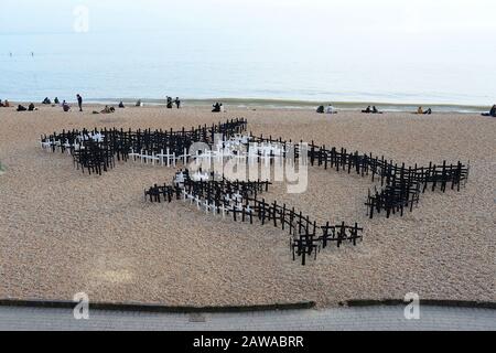 Brighton, Großbritannien, 10. März 2015. Hunderte schwarz-weiß bemalte Holzpfähle, die wie Kreuze geformt sind, sind im Schindel am Brighton Beach in Form eines Killerwals angeordnet und es ist Kalb in dieser Kunstinstallation mit dem Titel "Whale Graveyard - Sing Captive Spirits Free". Das riesige Kunststück, das anlässlich des WhaleFest Festivals 2015 der Stadt geschaffen wurde, wies 1.500 Kreuze auf. Jedes Kreuz stellt einen Wal oder Delphin dar, der in Gefangenschaft gestorben ist. Stockfoto