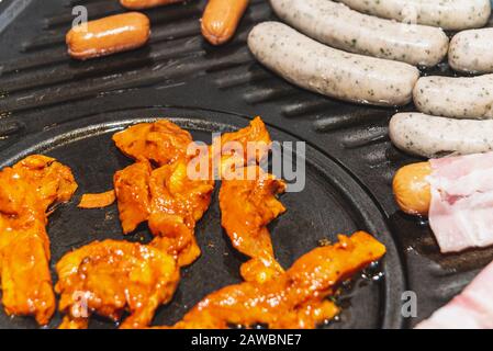 Auf dem heißen Stein werden verschiedene Fleischsorten zubereitet Stockfoto