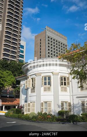 Teilansicht von CHIJMES, dem ehemaligen Kloster des Heiligen Säuglings-Jesus, jetzt in einen Restaurantstandort in Singapur umgestaltet; mit modernen Gebäuden in der b/g Stockfoto