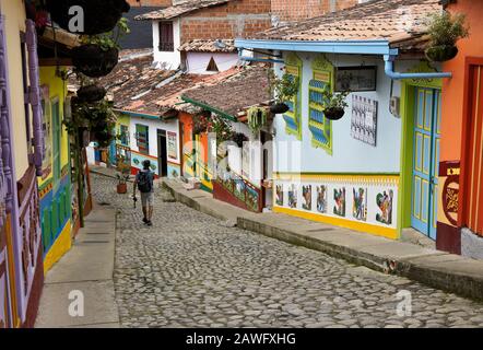 Farbenfrohe, ziegelgedeckte Gebäude, die mit der Linie Calle del Recuerdos (Friese), einer Kopfsteinpflaster Fußgängerzone in Guatape, Kolumbien, dekoriert sind Stockfoto