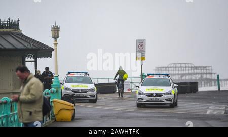 Brighton UK 9. Februar 2020 - die Polizei am Brighton Seafront, während Storm Ciara Großbritannien mit Bernsteinwarnungen im ganzen Land trifft, da mit hohen Winden Schäden und mögliche Lebensgefahr zu erwarten sind: Kredit Simon Dack / Alamy Live News Stockfoto