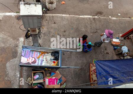 Obdachlose, in Armut lebende Geiselbote werden auf einem Bürgersteig in der Nähe ihres Schlafbereichs auf einem Bürgersteig in Kampong Cham, Kambodscha, versammelt. Stockfoto