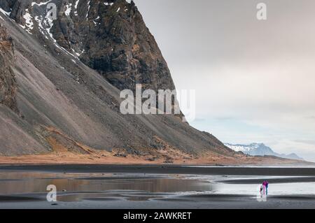 Unerkannte Menschen genießen die wunderbare und schöne Landschaft des Vestrahorn-Berges in der Nähe des Dorfes Hofn in Island Europa Stockfoto