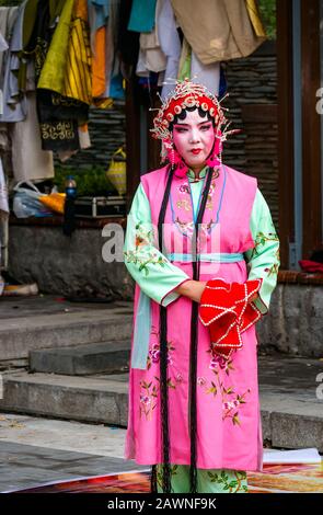 Mann, der die Oper Peking im Freien in bunten Kostümen vorführt, Xi Cheng Hutong District, Peking, China Stockfoto