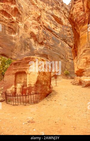 Ein Denkmal in der inneren Siq von Petra, Jordanien, das den Nabatäischen Gott Dushara darstellt. Schlitzschlucht und enge Schlucht entlang des Weges zum Finanzministerium in Petra Stockfoto