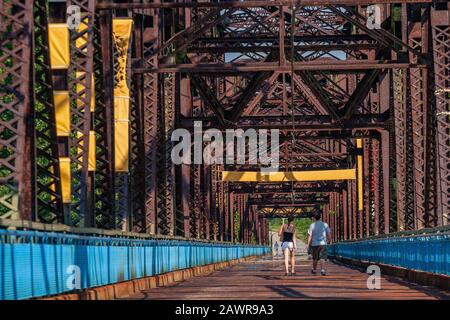 Zwei Personen, die auf der Old Chain of Rocks Bridge, der ehemaligen Route 66 über den Mississippi River, spazieren gehen Stockfoto