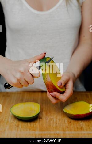 Frau Schneidet Mango-Früchte mit Scharfem Messer Stockfoto