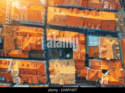 Luftansicht der Häuser mit orangefarbenen Dächern bei Sonnenuntergang im Sommer Stockfoto