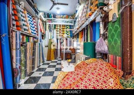 Schneidergeschäft mit vielen bunten Stoffen in der Altstadt von Marrakesch, Marokko Stockfoto