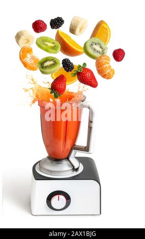 Mixer mit fliegenden Früchten auf isoliertem weißem Hintergrund, natürlichem Fruchtsaft Stockfoto