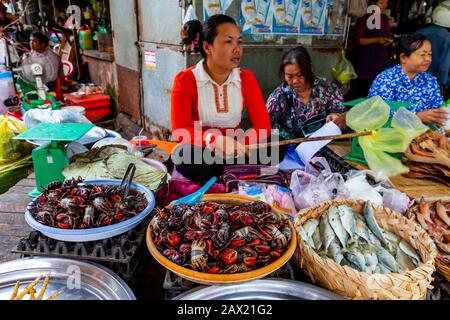 Eine Lokale Frau Hält Fliegen Fern Von Ihrem Meeresfrüchte-Stall Auf Dem Fischmarkt Psar Nath, Battambang, Kambodscha. Stockfoto