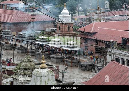 Beerdigungspyren werden viele Stunden lang gepflegt, bis kremierte Leichen im Pashupatinath-Hindu-Tempel und in den brennenden Ghats -Kathmandu Nepal in Asche verwandelt werden Stockfoto