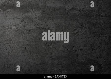 Textur, grunge schwarze Asphalt- oder Betonwand als Hintergrund Stockfoto