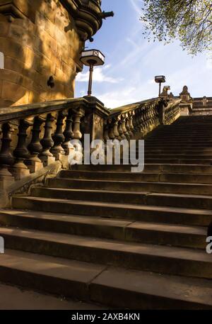 Treppe, die aus dem gefüllten Loch of Princess Street Gardens in Edinburgh führt, bedeckt mit dem angestrahlten Licht und Schatten Stockfoto