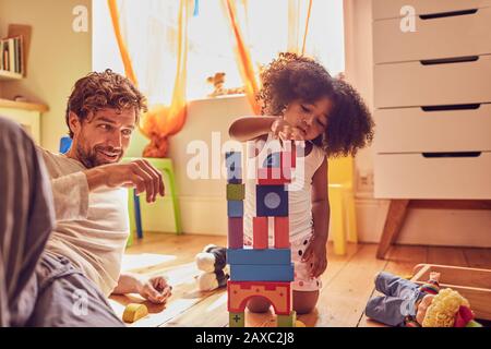 Vater und Tochter spielen mit Holzblöcken Stockfoto