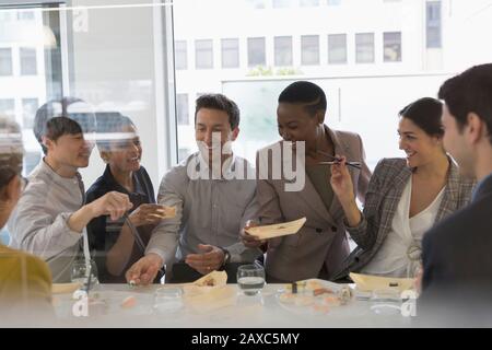 Fröhliche Geschäftsleute genießen Sushi-Mittagessen Stockfoto