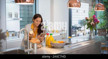 Frau mit digital-Tablette in Küche Stockfoto