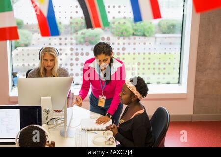 Dozentin der Community College hilft Studenten am Computer im Computerlabor Stockfoto