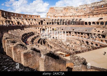 Ein weiter Blick auf das Innere des Kolosseum in Rom, Italien, mit Touristen, die umherstreifen. Stockfoto