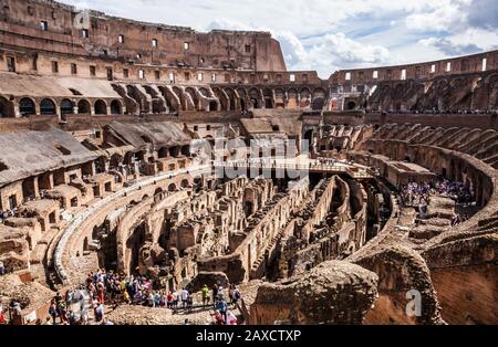 Ein weiter Blick auf das Innere des Kolosseum in Rom, Italien, mit Touristen, die umherstreifen. Stockfoto